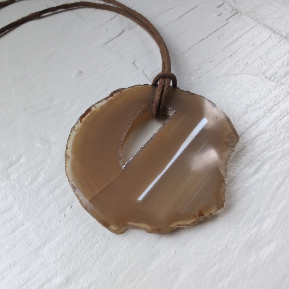 Brown and tan oversized agate geode slice pendant on brown real leather cord